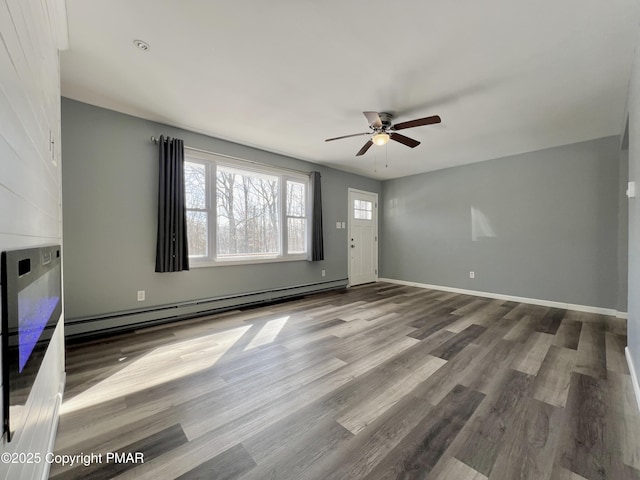 unfurnished living room featuring hardwood / wood-style flooring, ceiling fan, and baseboard heating