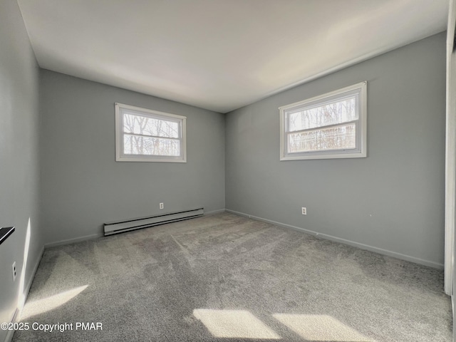 empty room with a baseboard radiator and light colored carpet