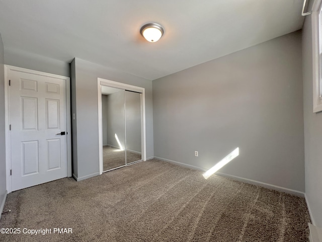 unfurnished bedroom with carpet flooring and a closet