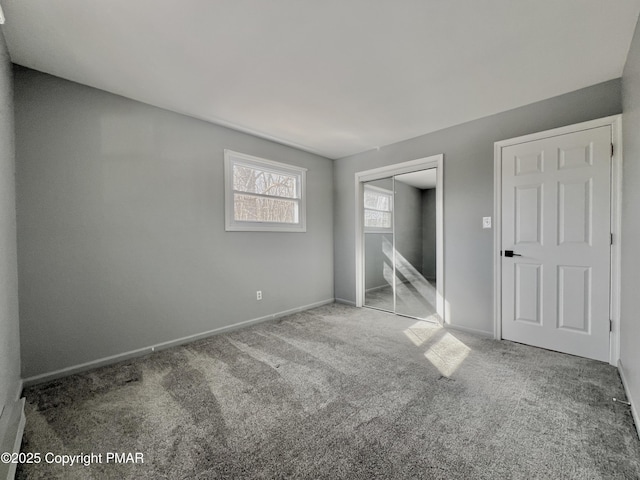 unfurnished bedroom featuring carpet floors and a closet