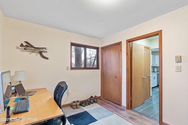 office area featuring baseboards and wood finished floors