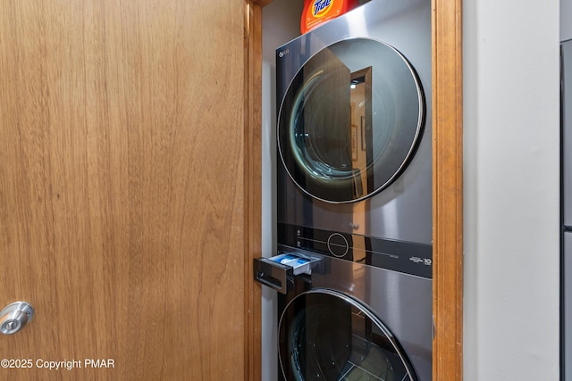 laundry room featuring stacked washer / dryer and laundry area