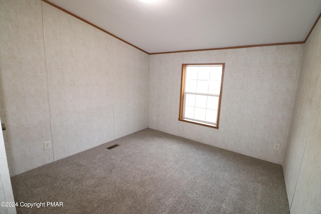 carpeted empty room featuring ornamental molding and visible vents