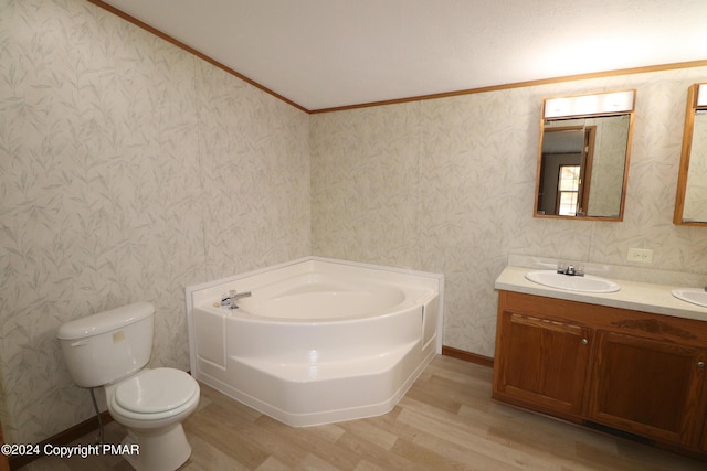 bathroom featuring a garden tub, toilet, wood finished floors, vanity, and wallpapered walls