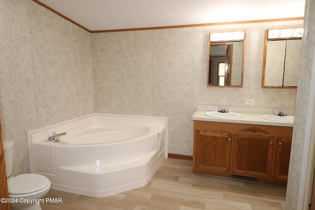 full bathroom featuring a garden tub, toilet, a sink, double vanity, and wallpapered walls