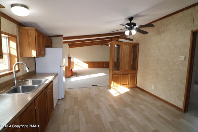 kitchen featuring brown cabinets, vaulted ceiling with beams, light wood-style flooring, white dishwasher, and a sink