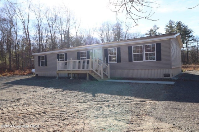 manufactured / mobile home featuring crawl space and a deck