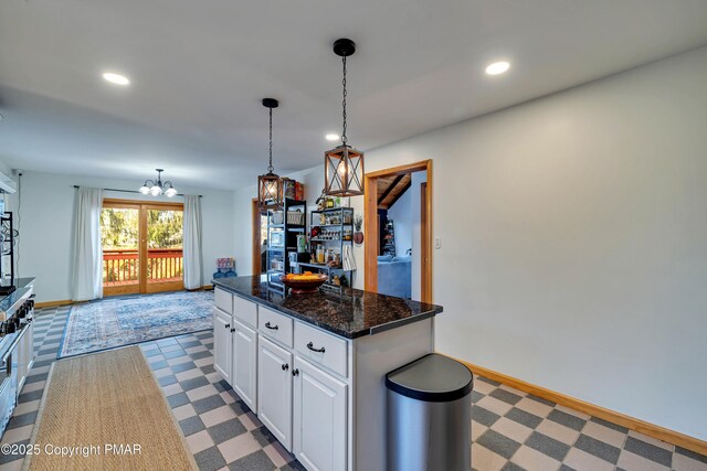 kitchen with white cabinetry, wall chimney exhaust hood, appliances with stainless steel finishes, and sink