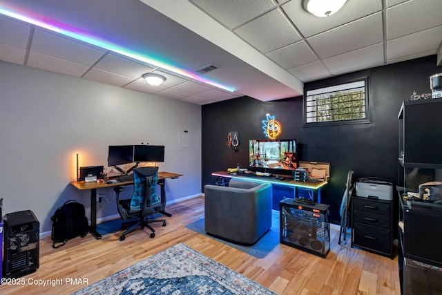 office area featuring a paneled ceiling and light wood-type flooring