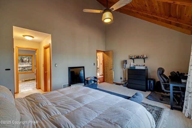 carpeted bedroom featuring beam ceiling, high vaulted ceiling, and wooden ceiling