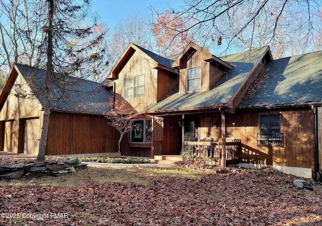 view of front of home with a porch and a garage