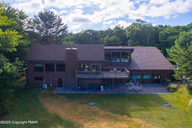 rear view of property featuring a yard, a patio area, and central air condition unit