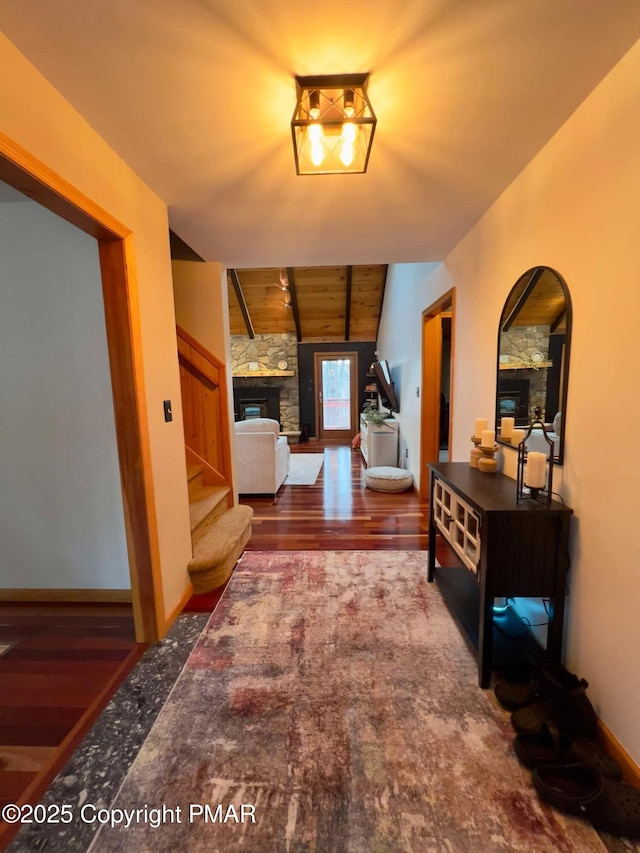 hallway featuring dark hardwood / wood-style flooring, vaulted ceiling with beams, and wood ceiling