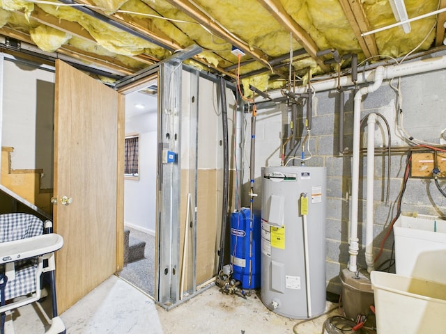 unfinished below grade area featuring water heater, stairway, and a sink