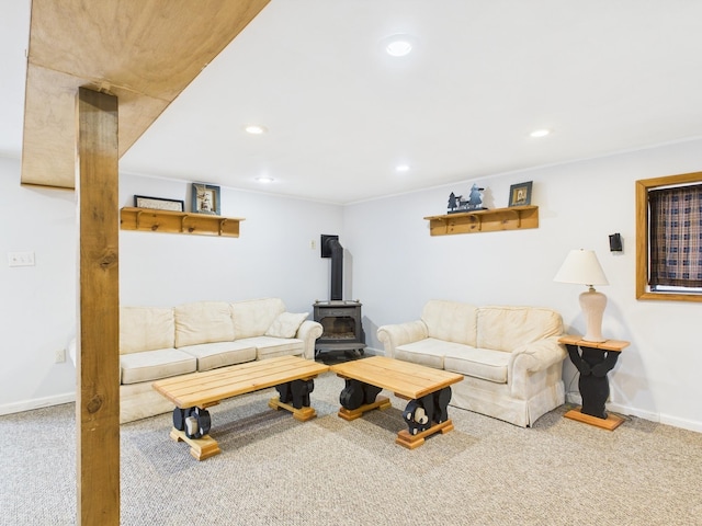 living room with a wood stove, carpet, baseboards, and recessed lighting