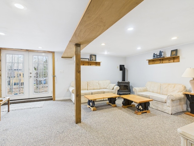 living room with carpet, a wood stove, and recessed lighting