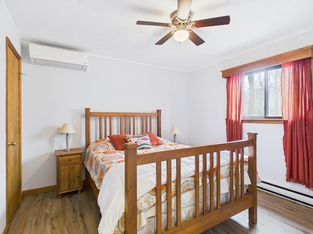 bedroom featuring ceiling fan, wood finished floors, baseboards, a wall mounted AC, and baseboard heating