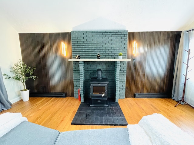 8540 Hillcrest Dr, Tobyhanna, PA 18466 - living room with a wood stove, wood finished floors, and baseboard heating