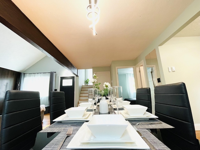8540 Hillcrest Dr, Tobyhanna, PA 18466 - dining room with wood finished floors, stairway, and beamed ceiling