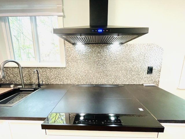 8540 Hillcrest Dr, Tobyhanna, PA 18466 - kitchen view of wall chimney exhaust hood, dark countertops, backsplash, and white cabinets