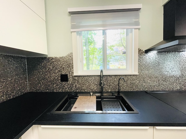 8540 Hillcrest Dr, Tobyhanna, PA 18466 - kitchen with wall chimney range hood, dark countertops, backsplash, and white cabinets