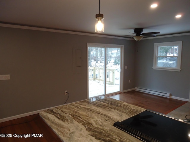 interior space with crown molding, a healthy amount of sunlight, and baseboard heating