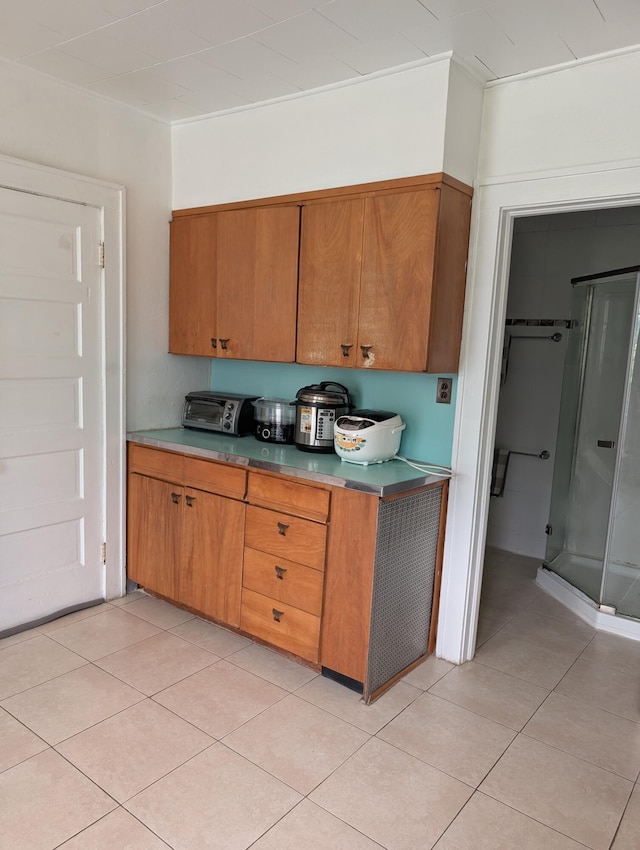 1105 Rte 390, Cresco, PA 18326 - kitchen with brown cabinetry and light tile patterned flooring