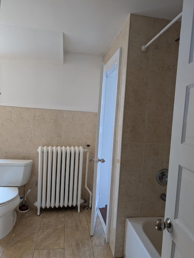 1105 Rte 390, Cresco, PA 18326 - bathroom with radiator heating unit, tile patterned flooring, tile walls, and bathing tub / shower combination