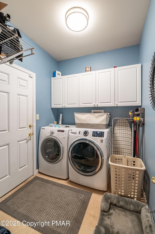 washroom featuring cabinets and separate washer and dryer