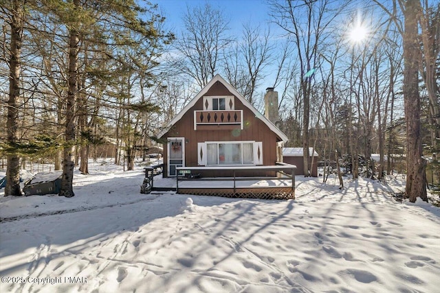 snow covered house with a deck