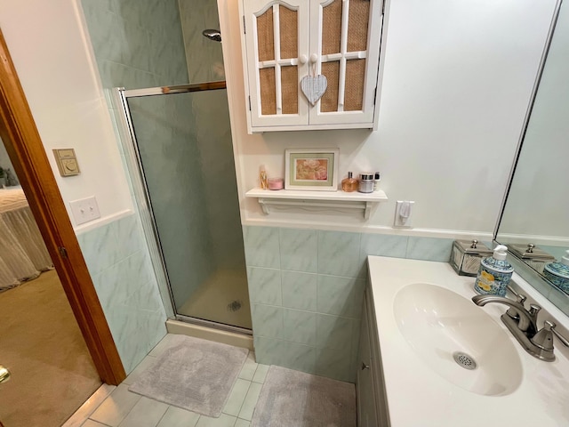 25 Cobblewood Dr, Mount Pocono, PA 18344 - bathroom with tile walls, a stall shower, tile patterned floors, vanity, and a wainscoted wall