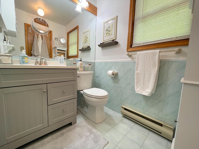25 Cobblewood Dr, Mount Pocono, PA 18344 - bathroom featuring a baseboard radiator, tile patterned floors, tile walls, vanity, and wainscoting