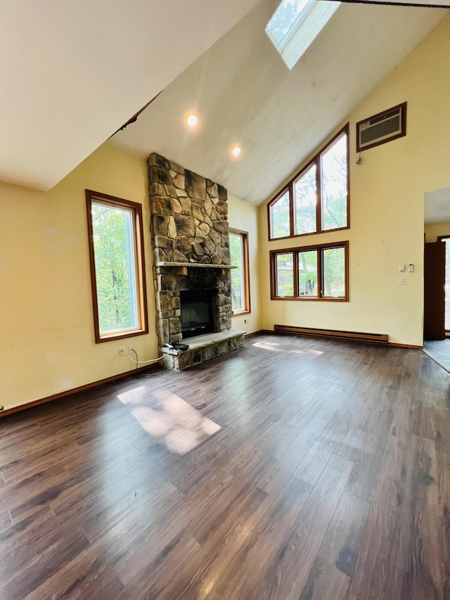 120 Totteridge Rd, Bushkill, PA 18324 - unfurnished living room with high vaulted ceiling, wood finished floors, a stone fireplace, a skylight, and a baseboard radiator