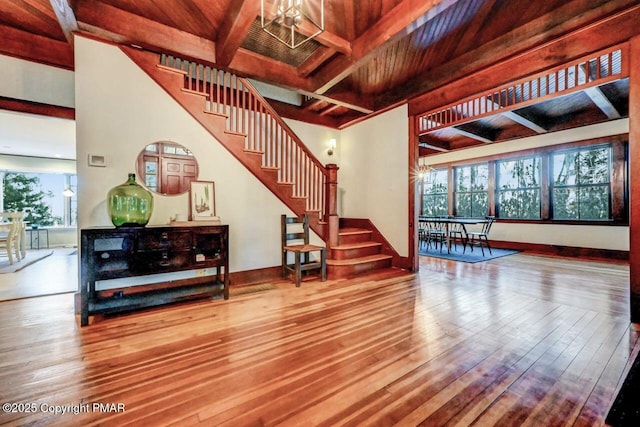 living room with wood-type flooring, stairway, and baseboards