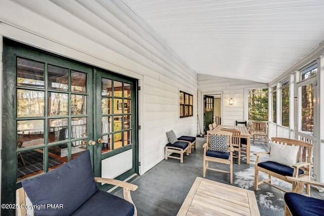 sunroom featuring lofted ceiling