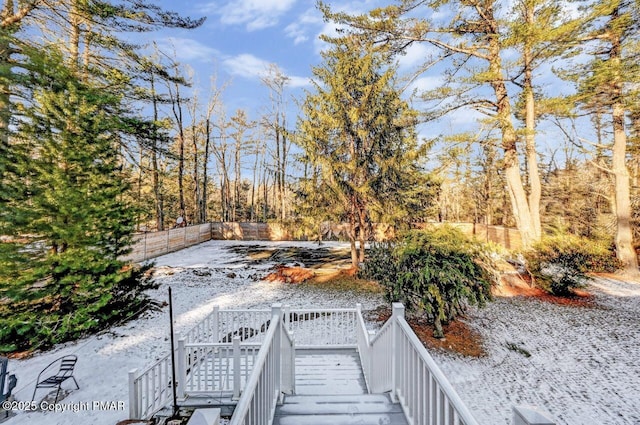 view of yard featuring fence and stairway