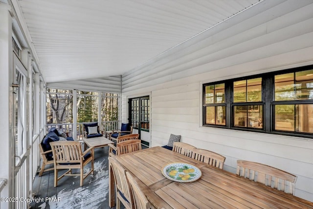 sunroom featuring vaulted ceiling