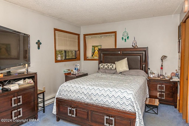 carpeted bedroom with baseboard heating and a textured ceiling