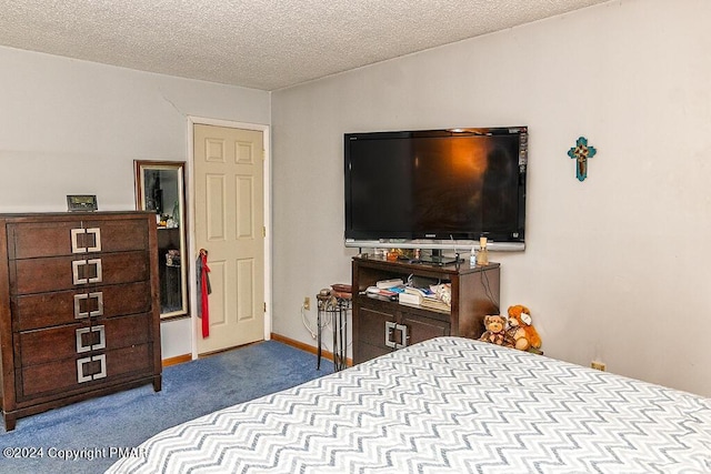 bedroom with baseboards, carpet floors, and a textured ceiling