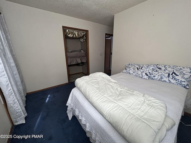 bedroom with carpet flooring, baseboards, a closet, and a textured ceiling