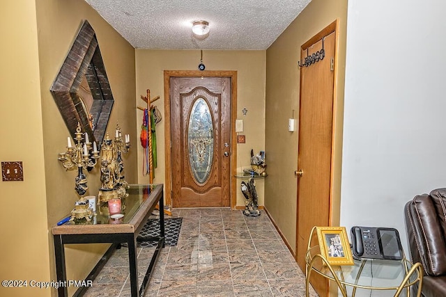 foyer entrance featuring a textured ceiling