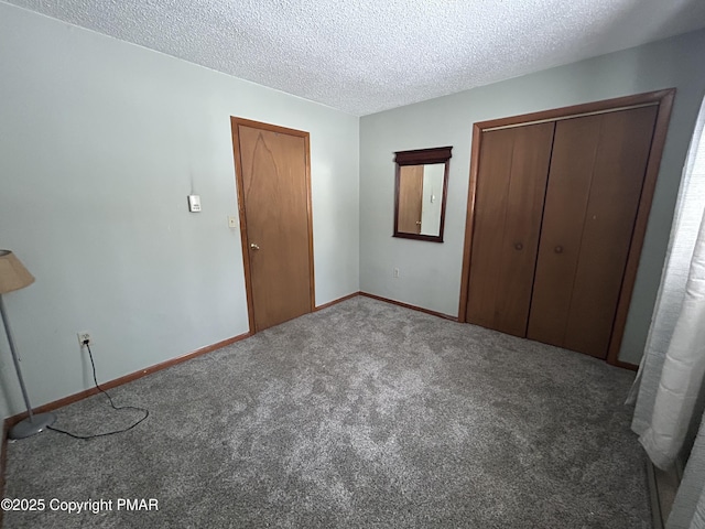 unfurnished bedroom with a closet, carpet floors, a textured ceiling, and baseboards