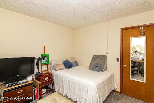 carpeted bedroom featuring a textured ceiling