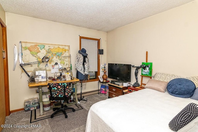 bedroom with a baseboard heating unit, baseboards, and a textured ceiling