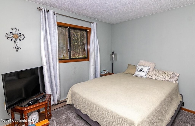 carpeted bedroom with a textured ceiling, baseboards, and a baseboard radiator