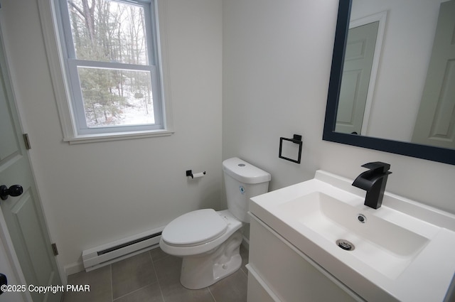 half bath featuring tile patterned flooring, toilet, vanity, and baseboard heating