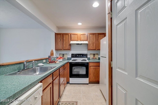 kitchen with recessed lighting, brown cabinetry, a sink, white appliances, and under cabinet range hood