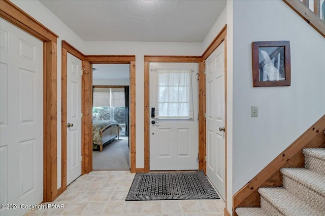 entrance foyer with baseboards and stairs