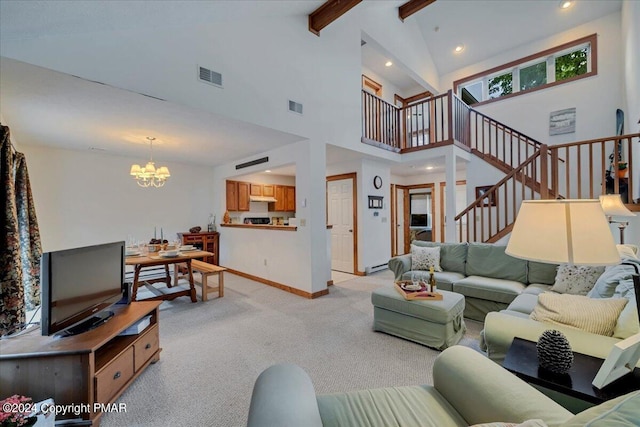 living room featuring stairway, a notable chandelier, visible vents, and beam ceiling