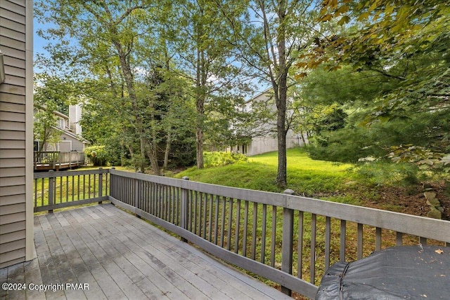 wooden terrace with a lawn